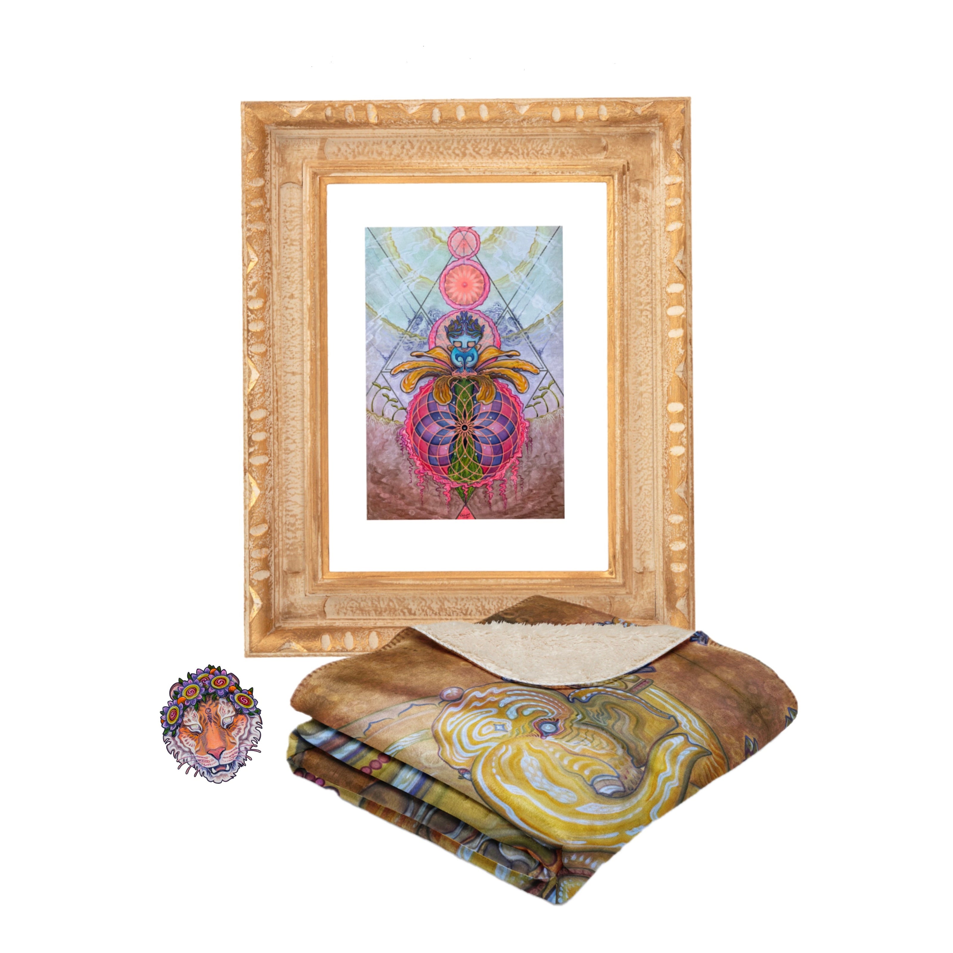 Abstract insect art in a simple frame, a sticker featuring a stylized lion face, and a folded brown fleece blanket with a vibrant multicolored lion design, neatly arranged on white.